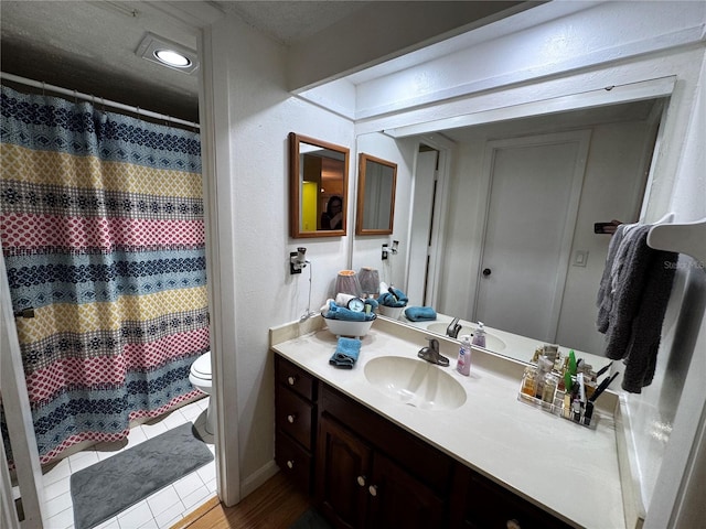 bathroom with vanity, toilet, and tile patterned flooring