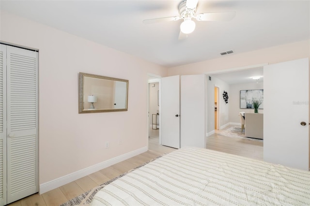 bedroom with ceiling fan, a closet, and light wood-type flooring