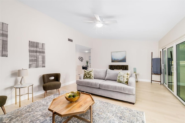 living room with ceiling fan and lofted ceiling