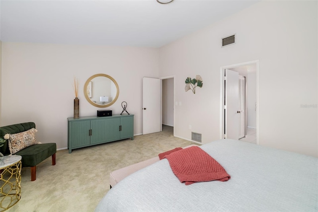 carpeted bedroom featuring a towering ceiling and connected bathroom