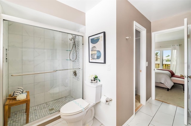 bathroom with tile patterned floors, toilet, and walk in shower