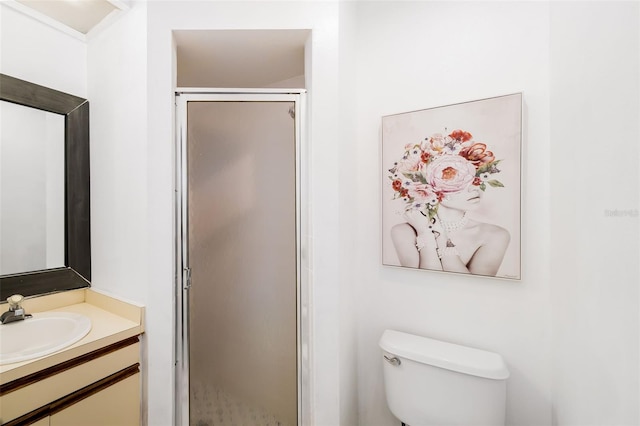 bathroom featuring toilet, an enclosed shower, and vanity