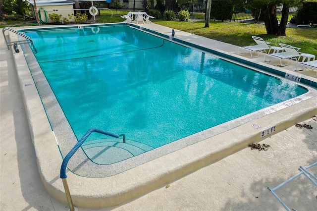 view of pool featuring a yard