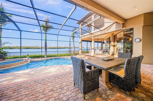 view of pool with an in ground hot tub, a water view, and a patio