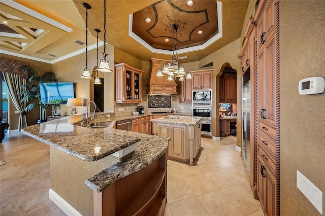 kitchen with kitchen peninsula, a kitchen island, built in microwave, and hanging light fixtures