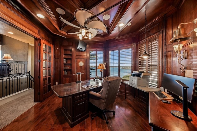 office area featuring crown molding, ceiling fan, dark wood-type flooring, and coffered ceiling