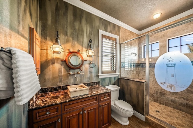 bathroom with vanity, crown molding, toilet, a textured ceiling, and walk in shower