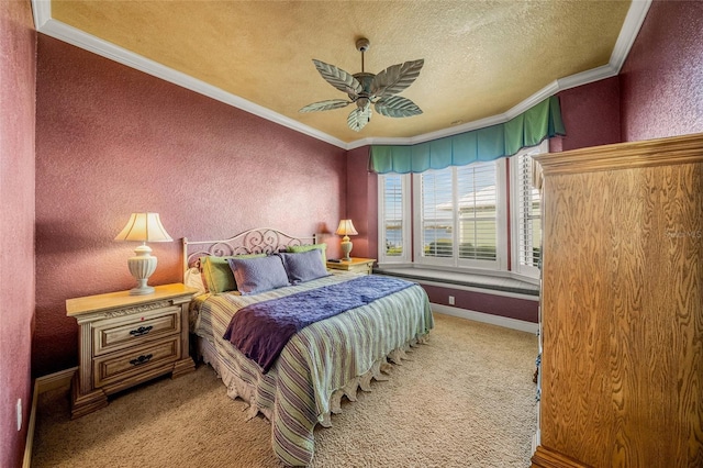 carpeted bedroom with ceiling fan, crown molding, and a textured ceiling