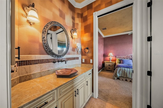 bathroom with tile patterned floors, crown molding, and vanity