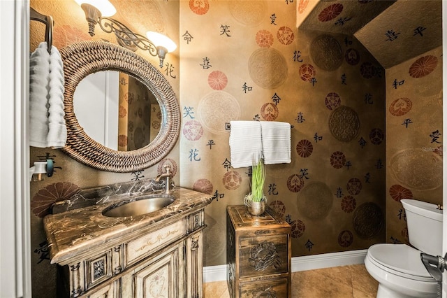 bathroom featuring tile patterned floors, vanity, and toilet