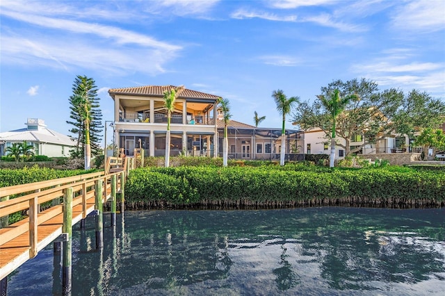 rear view of property with a water view and a balcony