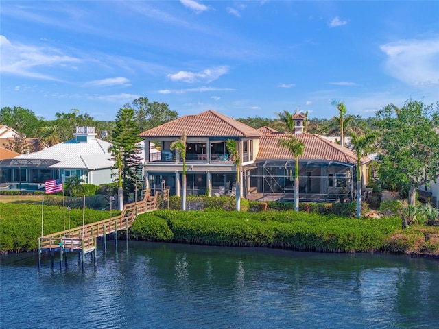 back of house featuring a water view and a balcony