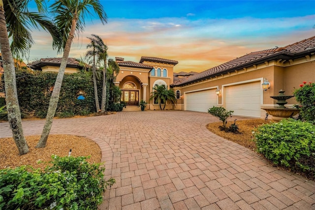 mediterranean / spanish house with a garage