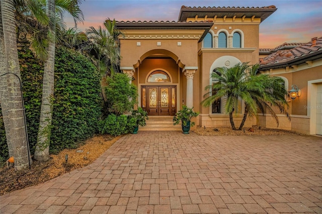 view of exterior entry at dusk