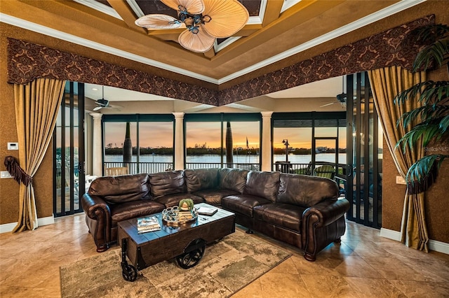 living room with a water view, plenty of natural light, ceiling fan, and crown molding