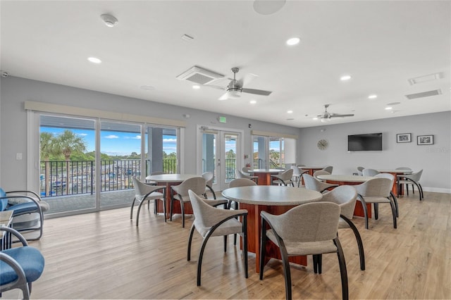 dining space with ceiling fan, french doors, and light wood-type flooring