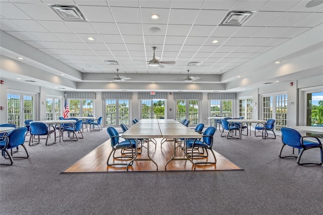 carpeted dining room with french doors, ceiling fan, and a healthy amount of sunlight