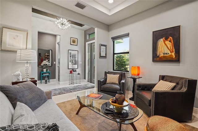 living room with hardwood / wood-style floors and a chandelier