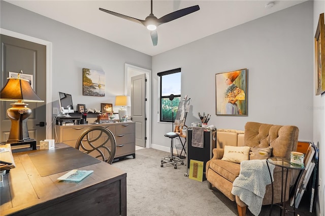 carpeted home office with ceiling fan