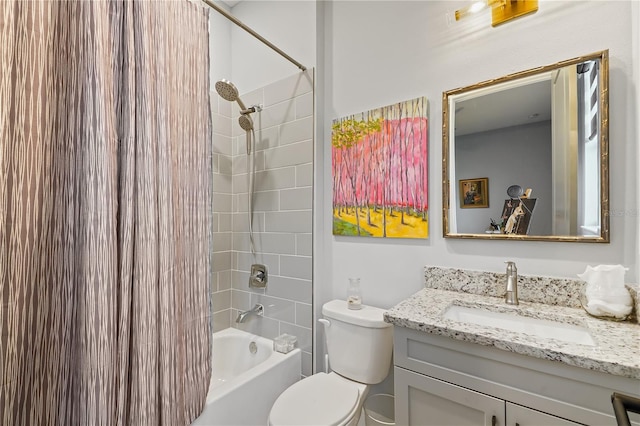 full bathroom featuring vanity, tiled shower / bath, and toilet