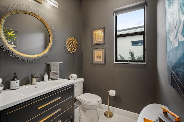 bathroom featuring vanity and toilet