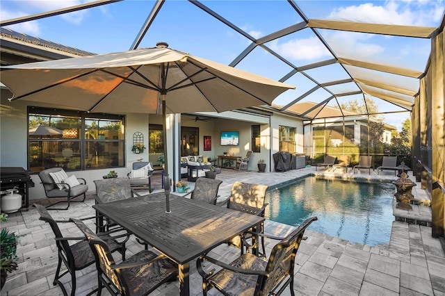 view of swimming pool with ceiling fan, a lanai, a patio, and pool water feature