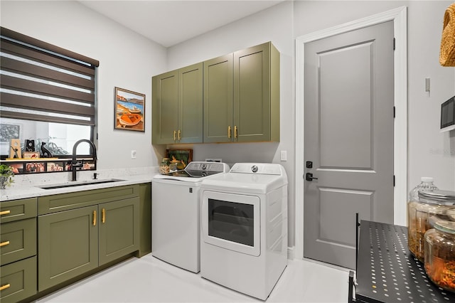 laundry area with sink, cabinets, and washing machine and clothes dryer