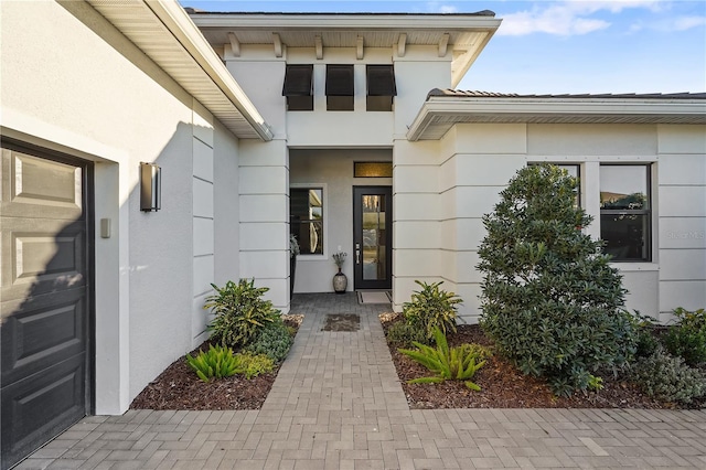 doorway to property with a garage