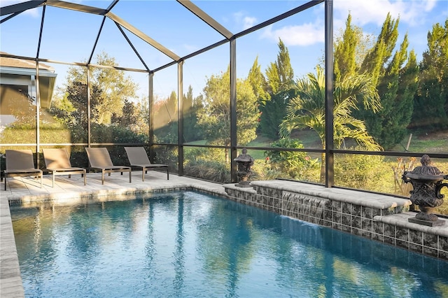 view of pool with pool water feature, a patio, and glass enclosure