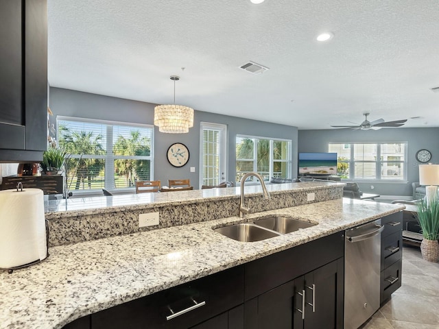 3450 77th St W Unit 102, Bradenton, FL 34209 - kitchen featuring stainless steel dishwasher, a textured ceiling, plenty of natural light, open floor plan, and recessed lighting