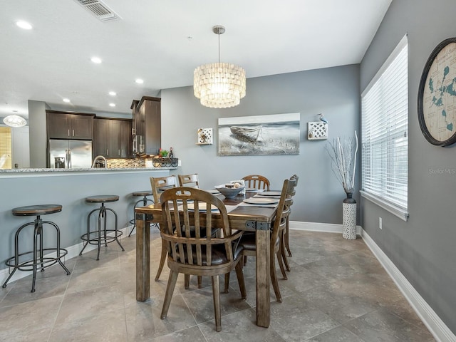 3450 77th St W Unit 102, Bradenton, FL 34209 - dining room featuring a chandelier and recessed lighting