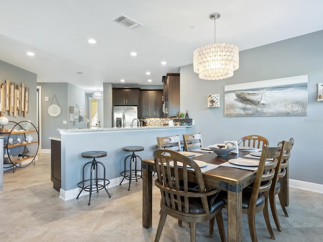 dining space with a chandelier