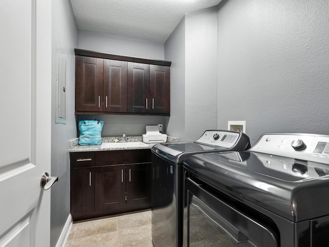 3450 77th St W Unit 102, Bradenton, FL 34209 - laundry area featuring separate washer and dryer, cabinet space, and a textured ceiling