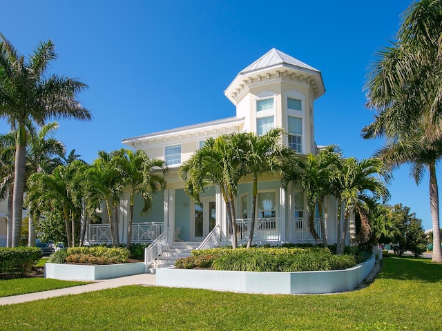 view of front facade with a front yard and a porch