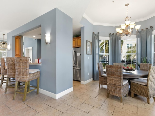 dining room featuring ornamental molding and a notable chandelier