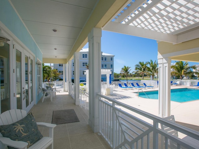 3450 77th St W Unit 102, Bradenton, FL 34209 - view of patio with french doors, a community pool, and a pergola