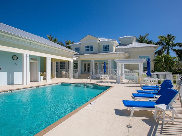 view of swimming pool with french doors, a pergola, and a patio area