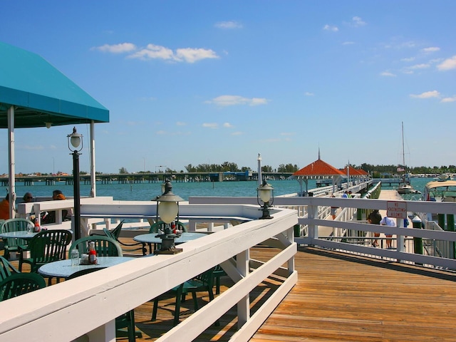3450 77th St W Unit 102, Bradenton, FL 34209 - wooden terrace with a water view and a boat dock