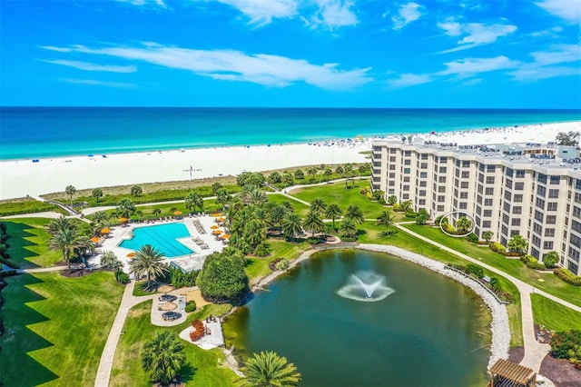 drone / aerial view with a water view and a beach view