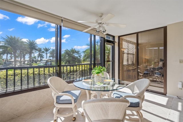 sunroom / solarium featuring ceiling fan