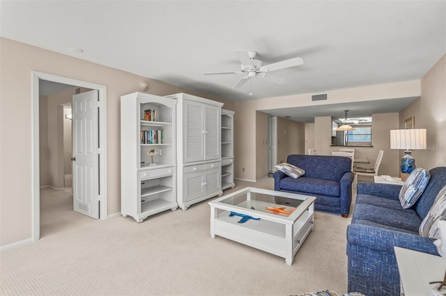 living room featuring light carpet and ceiling fan