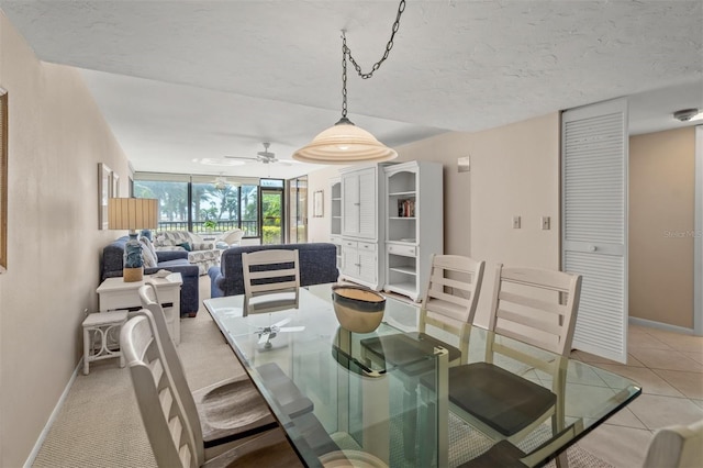 tiled dining room featuring ceiling fan and a textured ceiling