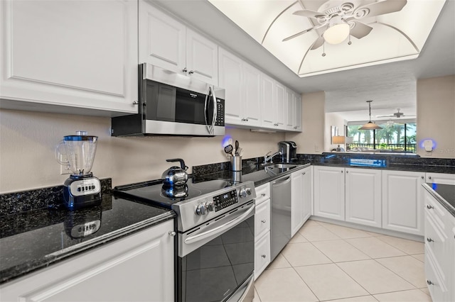 kitchen featuring pendant lighting, white cabinets, ceiling fan, appliances with stainless steel finishes, and light tile patterned flooring