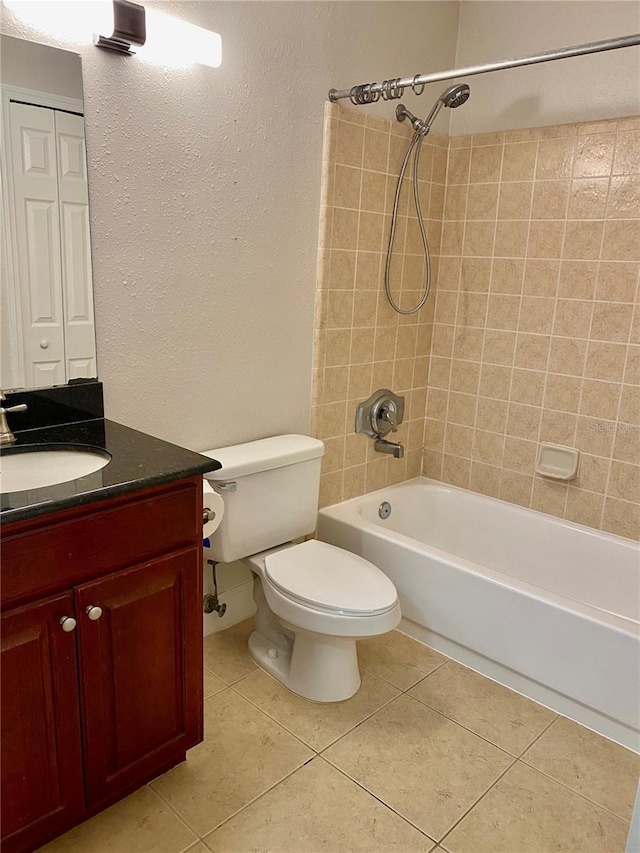 full bathroom with tile patterned floors, vanity, toilet, and tiled shower / bath