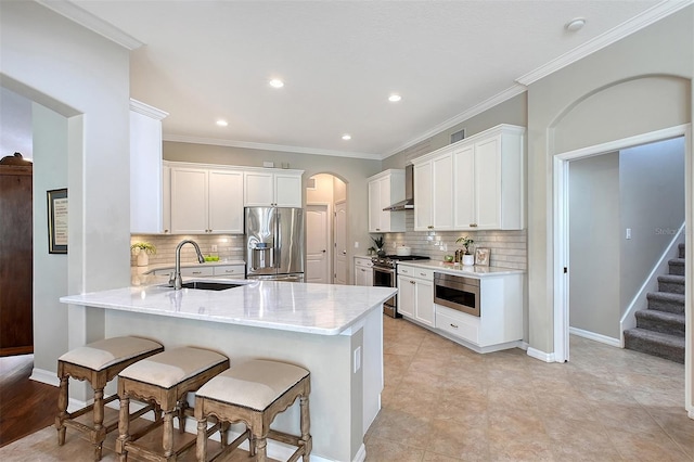 kitchen with stainless steel appliances, white cabinetry, and a sink