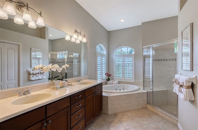 full bath featuring a garden tub, a shower stall, a sink, and tile patterned floors