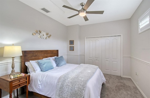 carpeted bedroom featuring baseboards, a closet, visible vents, and a ceiling fan