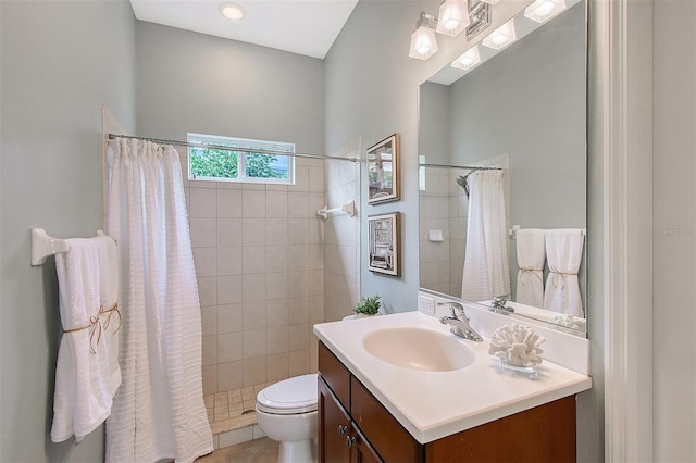 full bath with a stall shower, vanity, and toilet