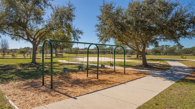 community jungle gym with a lawn