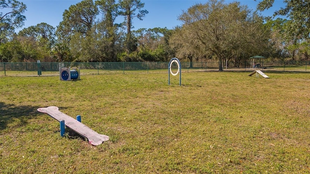 surrounding community featuring a lawn and fence